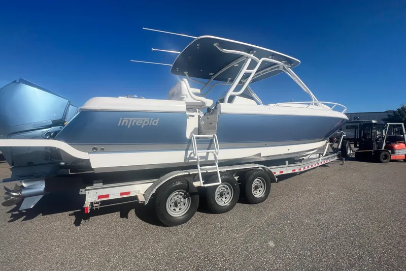 Slide: The Image of 2022 Intrepid 327-I CC boat on trailer under clear blue sky. - 45