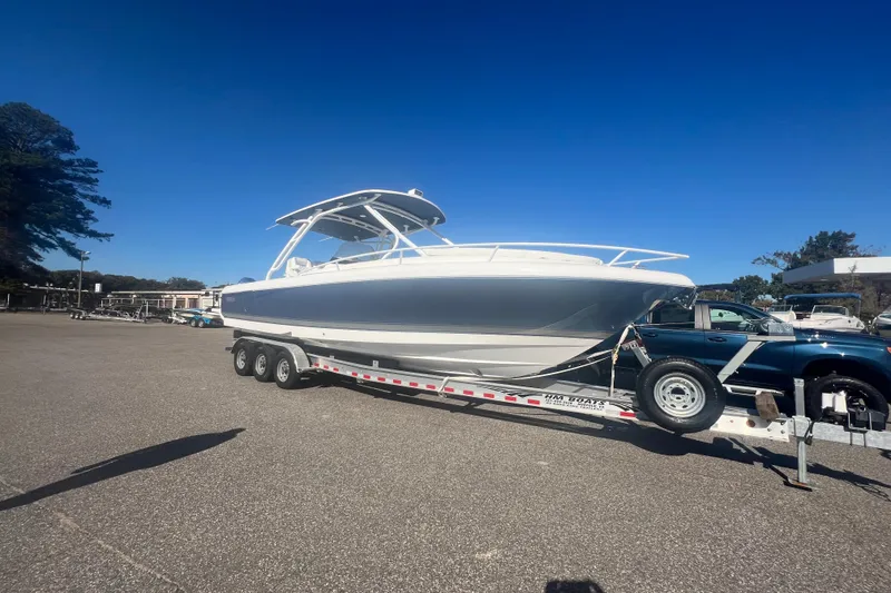 Slide: The Image of 2022 Intrepid 327-I CC boat on trailer under clear blue sky. - 46