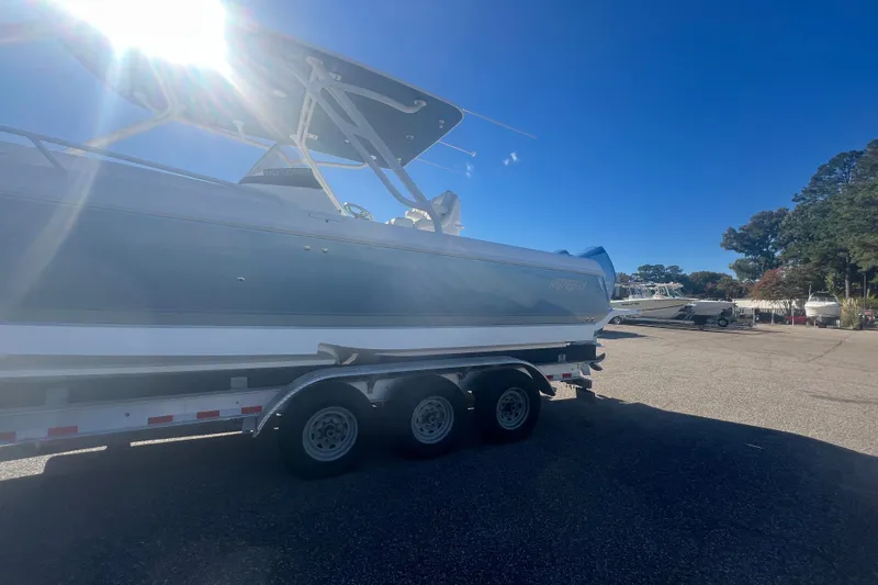 Slide: The Image of 2022 Intrepid 327-I CC boat on trailer under bright sunlight. - 49