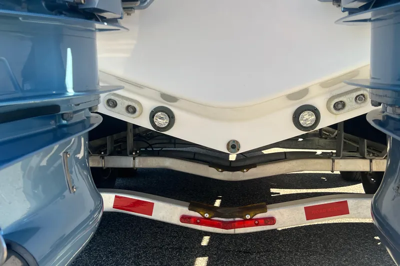 Slide: The Image of 2022 Intrepid 327-I CC boat on trailer, close-up of hull and outboard motors. - 55