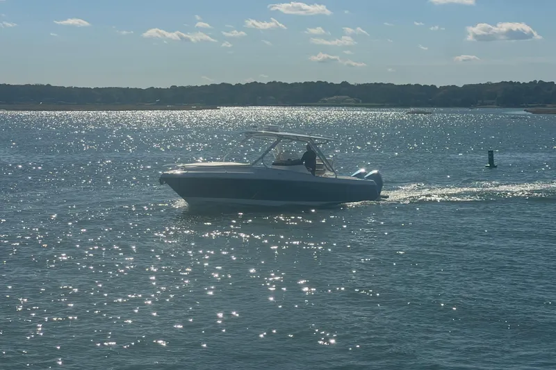 Slide: The Image of Intrepid 327-I CC 2022 boat cruising on sparkling water under a sunny sky. - 58