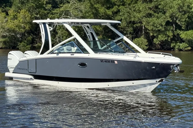 The Image of 2025 Chaparral 280 OSX boat on water, sleek design, forest background. - 0