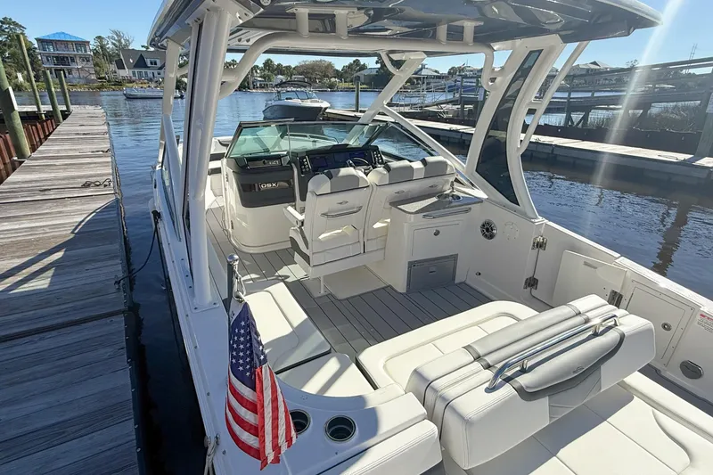 Slide: The Image of Twin Yamaha outboard engines on a 2025 Chaparral 280 OSX boat at a dock. - 10