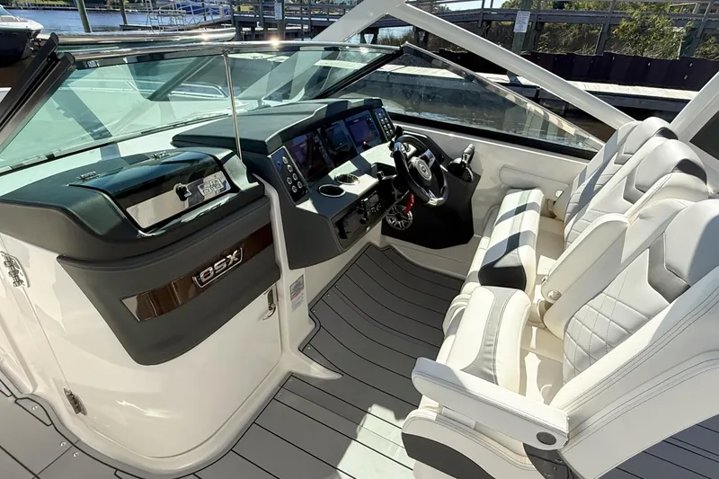 Slide: The Image of 2025 Chaparral 280 OSX boat interior with sleek design and spacious seating. - 11