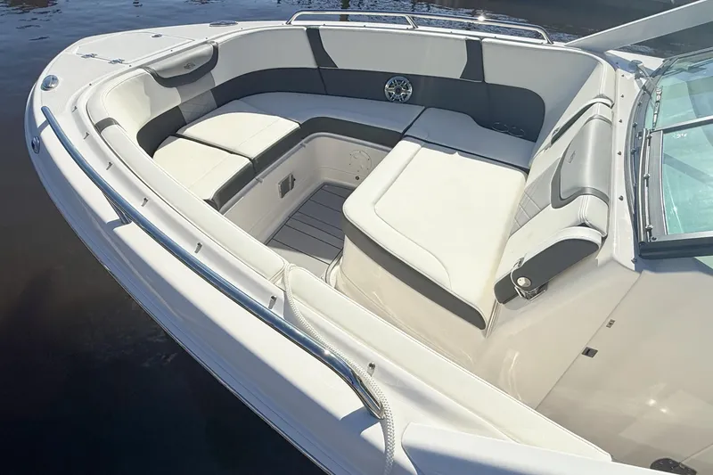 Slide: The Image of 2025 Chaparral 280 OSX boat interior with white seating and American flag. - 12