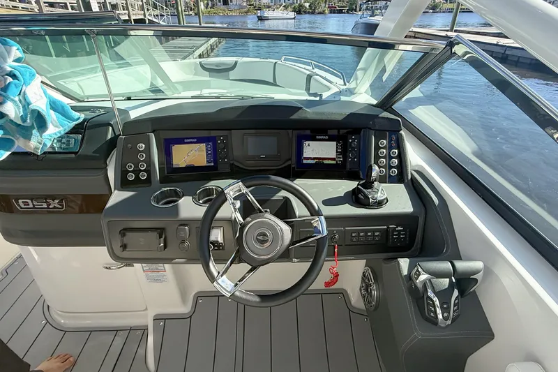 Slide: The Image of Luxury seating on 2025 Chaparral 280 OSX boat, featuring elegant white and gray upholstery. - 13