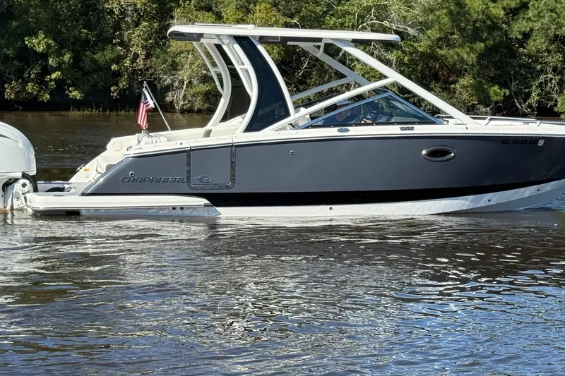 Slide: The Image of 2025 Chaparral 280 OSX boat with Yamaha engines on a calm river. - 2