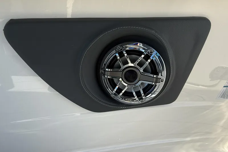 Slide: The Image of 2025 Chaparral 280 OSX boat interior with cushioned seating and built-in speaker. - 29