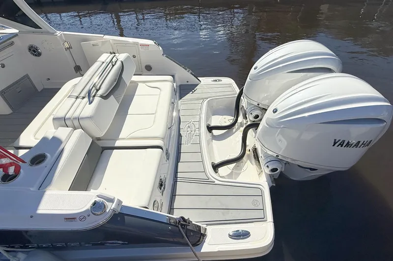 Slide: The Image of 2025 Chaparral 280 OSX boat interior with white seating and sleek design. - 6