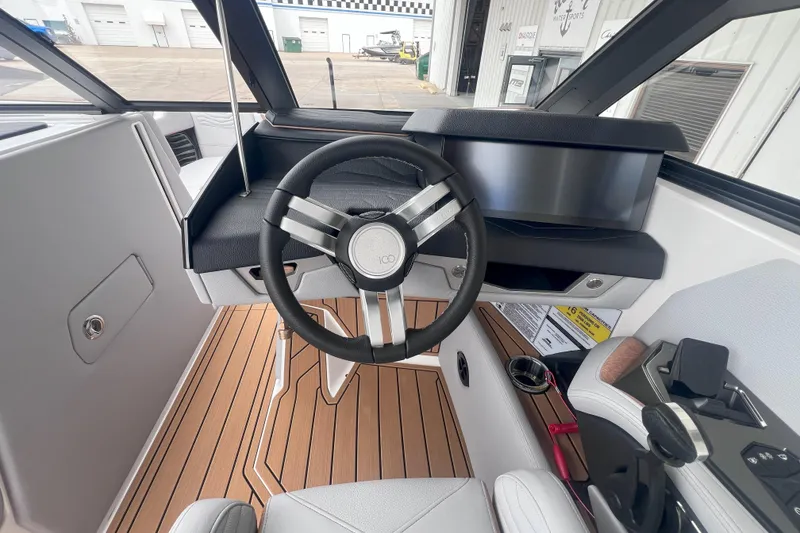 Slide: The Image of 2025 Nautique Super Air Nautique G23 helm with modern steering and controls. - 11
