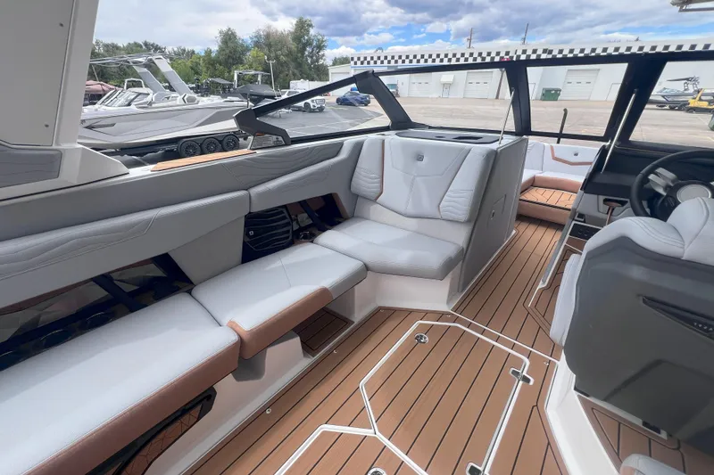Slide: The Image of 2025 Nautique Super Air Nautique G23 interior with luxurious seating and modern design. - 12