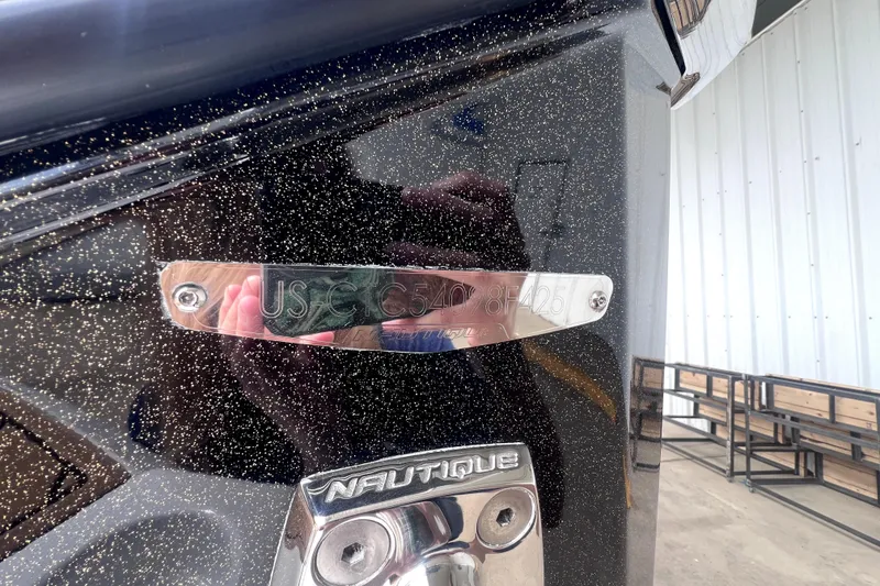 Slide: The Image of 2025 Nautique Super Air Nautique G23 boat with metallic finish and identification plate. - 17