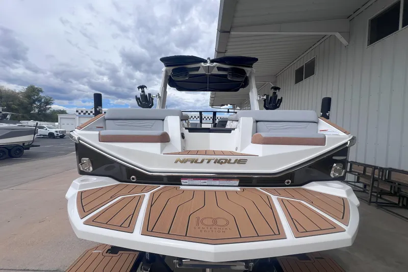 Slide: The Image of 2025 Nautique Super Air Nautique G23 boat, rear view, showcasing sleek design and spacious seating. - 4