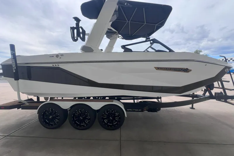 Slide: The Image of 2025 Nautique Super Air Nautique G23 boat on trailer, side view. - 6