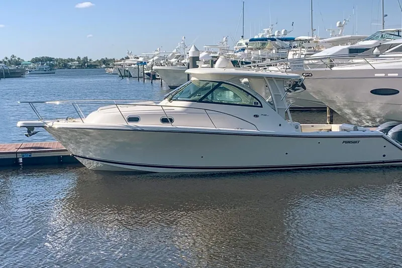 The Image of 2012 Pursuit OS 345 Offshore boat on calm water under a partly cloudy sky. - 0