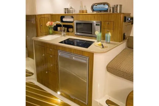 Slide: The Image of 2012 Pursuit OS 345 Offshore boat dashboard with navigation screens and controls. - 12