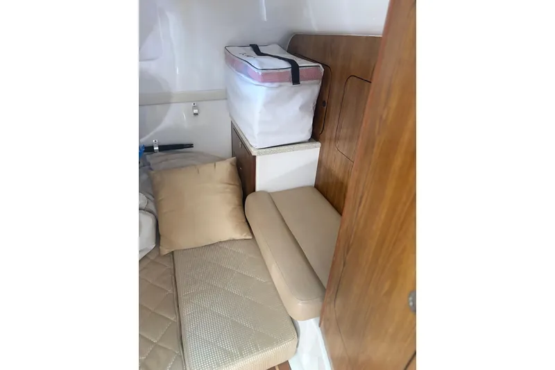 Slide: The Image of Luxurious interior seating of 2012 Pursuit OS 345 Offshore boat, featuring cream leather upholstery. - 14