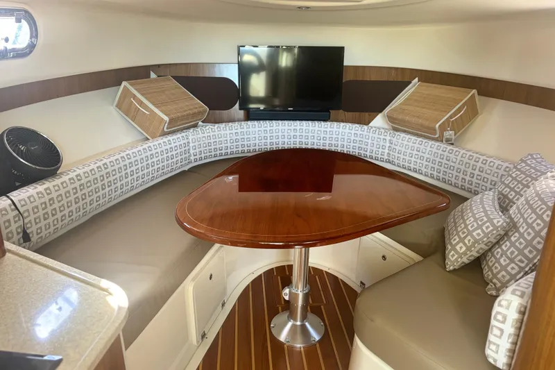 Slide: The Image of 2012 Pursuit OS 345 Offshore boat helm with Garmin navigation system and steering wheel. - 15