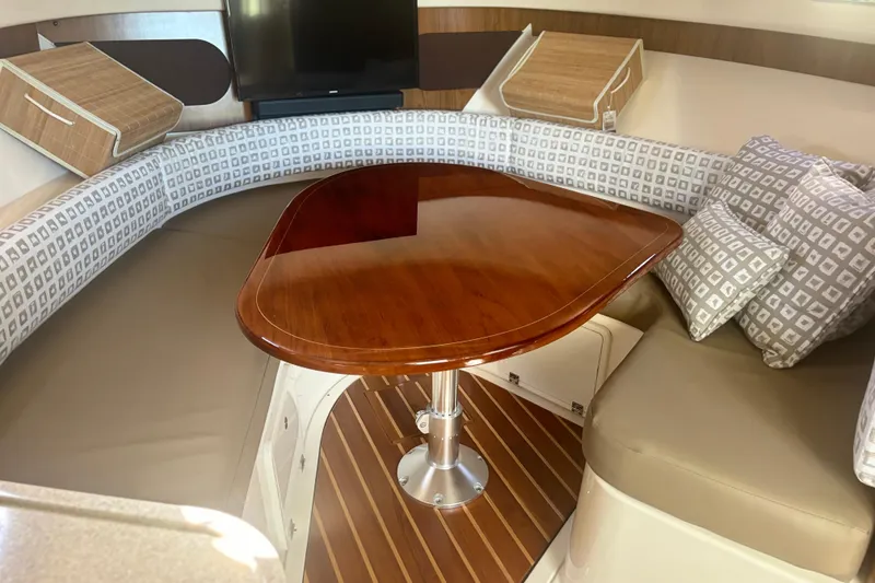 Slide: The Image of Luxurious interior of 2012 Pursuit OS 345 Offshore boat with elegant wood table and seating. - 22