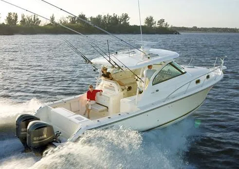 Slide: The Image of 2012 Pursuit OS 345 Offshore boat on calm water under cloudy sky. - 4