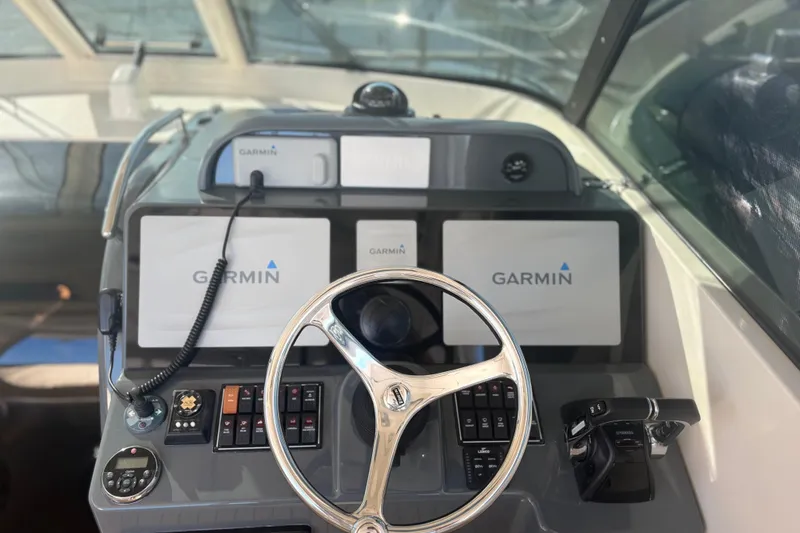 Slide: The Image of 2012 Pursuit OS 345 Offshore boat docked at marina, calm water, clear sky. - 6