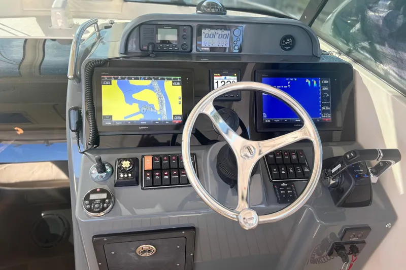 Slide: The Image of 2012 Pursuit OS 345 Offshore boat on lift, surrounded by tropical scenery. - 7