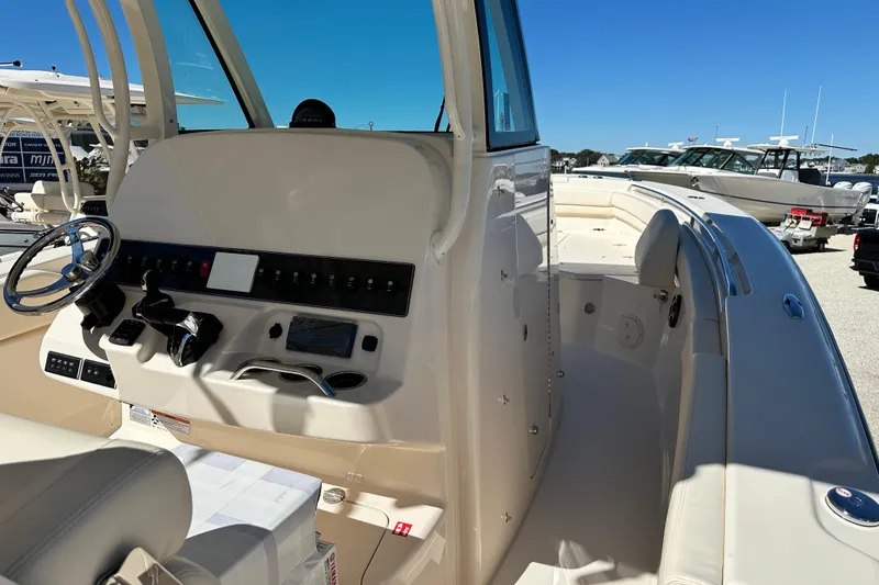 Slide: The Image of 2026 Grady-White Canyon 306 boat interior with helm and seating area. - 10