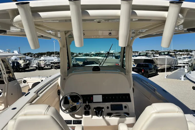 Slide: The Image of 2026 Grady-White Canyon 306 boat interior with steering wheel and control panel. - 11