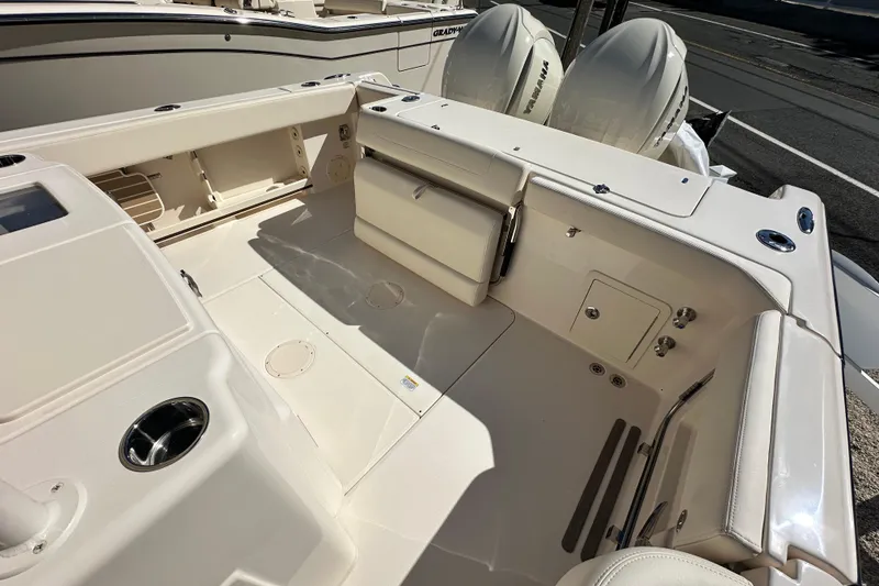 Slide: The Image of 2026 Grady-White Canyon 306 boat interior with dual engines and spacious deck layout. - 13