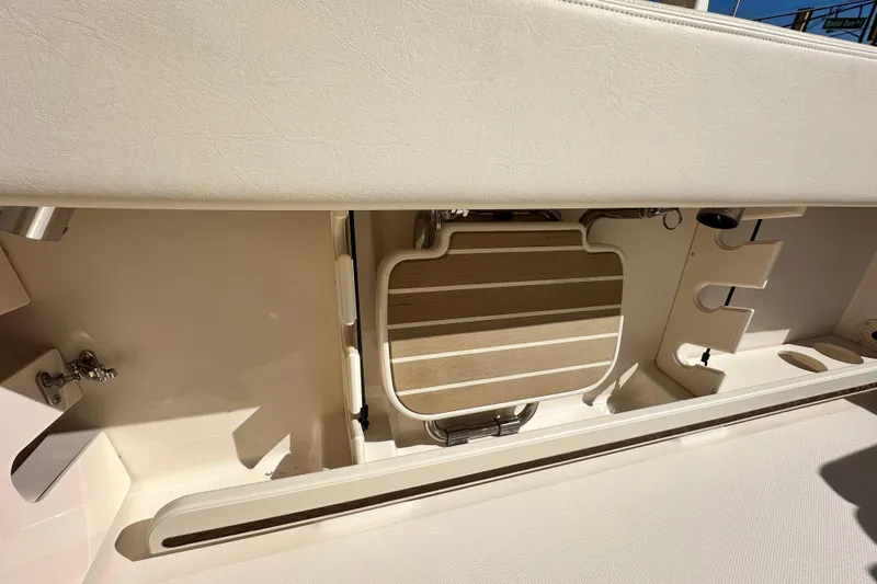 Slide: The Image of 2026 Grady-White Canyon 306 boat interior, featuring storage compartments and seating area. - 14