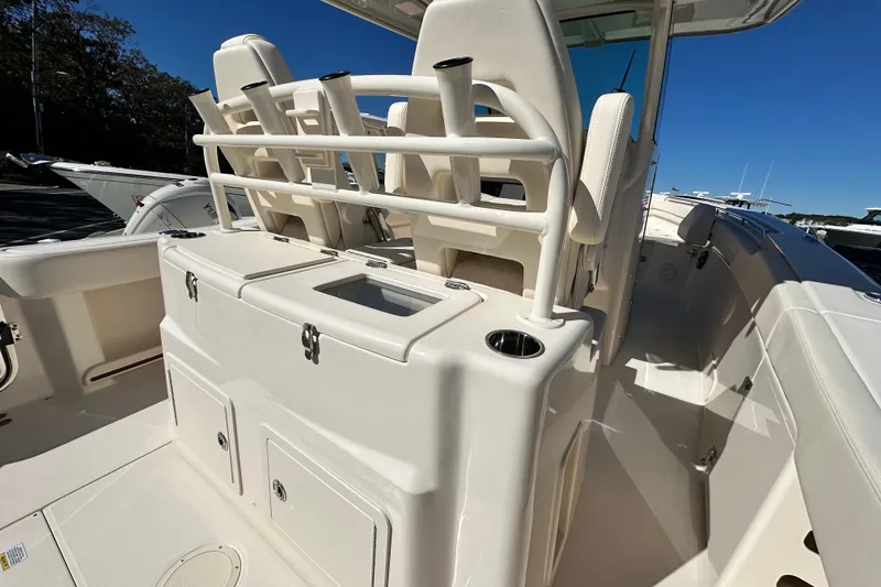 Slide: The Image of 2026 Grady-White Canyon 306 boat interior with rod holders and storage compartments. - 15