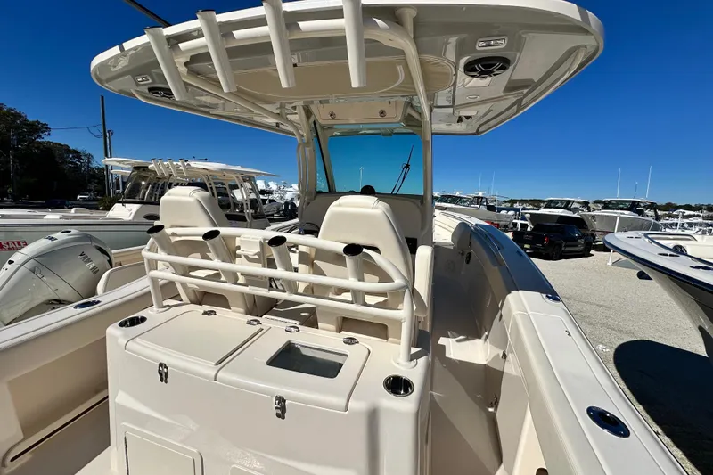 Slide: The Image of 2026 Grady-White Canyon 306 boat interior with seating and console, displayed outdoors. - 16