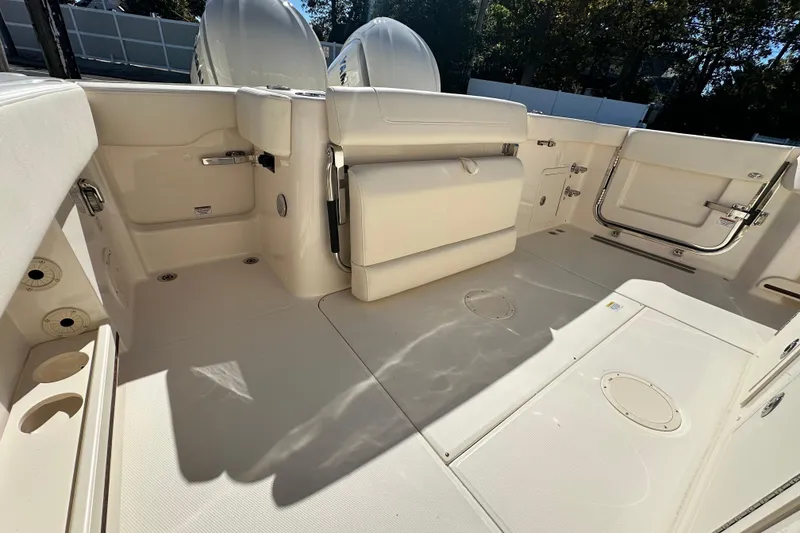 Slide: The Image of 2026 Grady-White Canyon 306 boat interior, featuring spacious deck and seating area. - 17