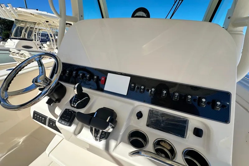 Slide: The Image of Helm of 2026 Grady-White Canyon 306 boat with steering wheel and control panel. - 19