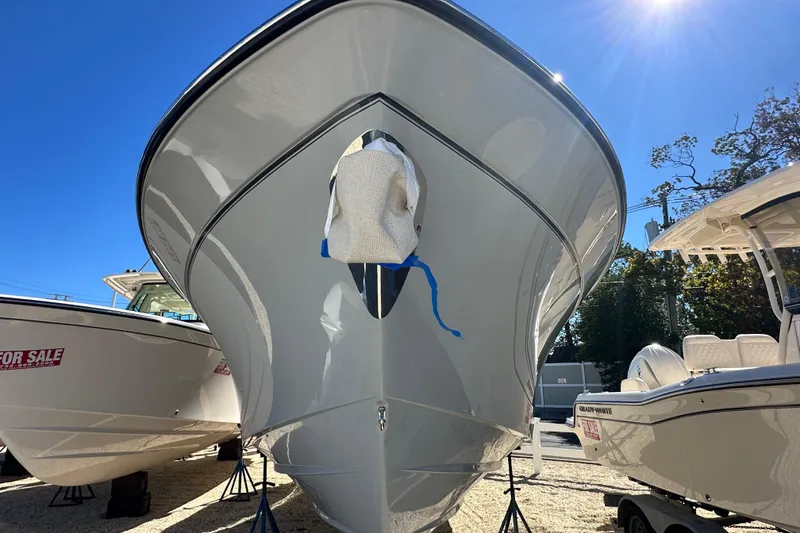Slide: The Image of 2026 Grady-White Canyon 306 boat on display under bright sunlight. - 5