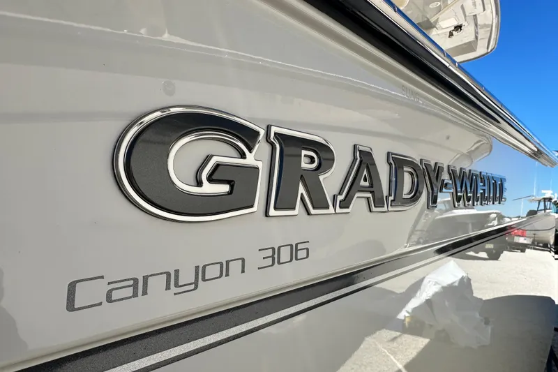 Slide: The Image of 2026 Grady-White Canyon 306 boat logo on sleek white hull. - 6