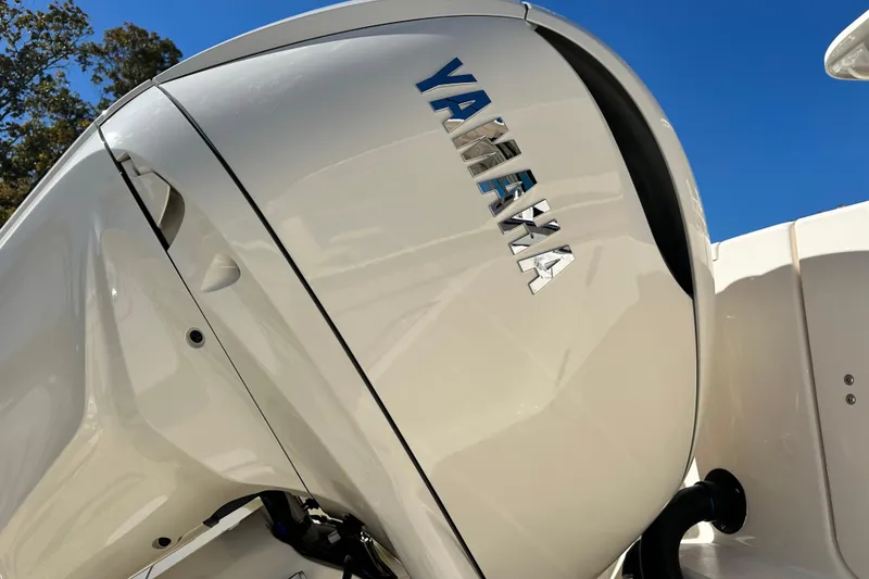 Slide: The Image of 2026 Grady-White Canyon 306 with Yamaha outboard motor, under clear blue sky. - 7