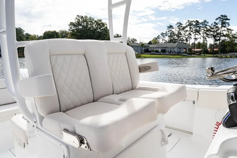 Slide: The Image of 2026 Sea Hunt Ultra 285 Coffin Box boat interior with dual engines on water. - 10