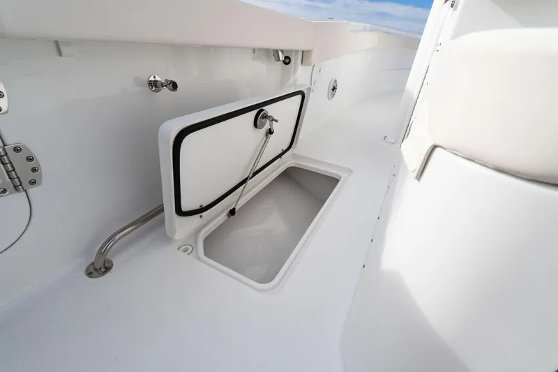 Slide: The Image of 2026 Sea Hunt Ultra 285 Coffin Box open storage compartment on deck. - 13