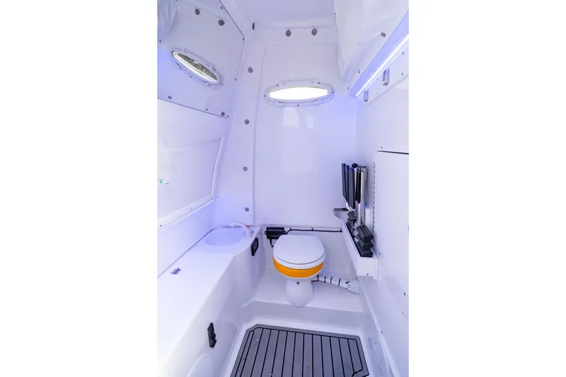 Slide: The Image of Interior of 2026 Sea Hunt Ultra 285 Coffin Box boat, featuring a compact bathroom. - 18