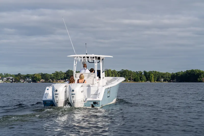 Slide: The Image of 2026 Sea Hunt Ultra 285 Coffin Box boat cruising on a lake with passengers. - 27