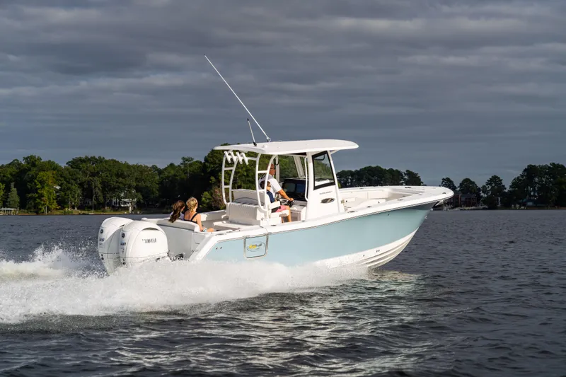 Slide: The Image of 2026 Sea Hunt Ultra 285 Coffin Box boat cruising on a lake under cloudy skies. - 28