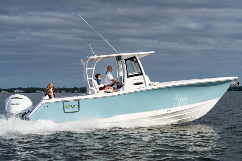 Slide: The Image of 2026 Sea Hunt Ultra 285 Coffin Box boat cruising on water under cloudy sky. - 29