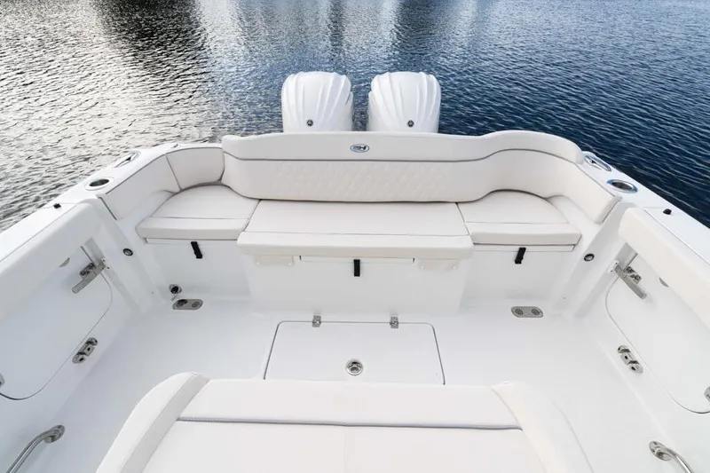 Slide: The Image of 2026 Sea Hunt Ultra 285 Coffin Box boat interior with cushioned seating and water view. - 3