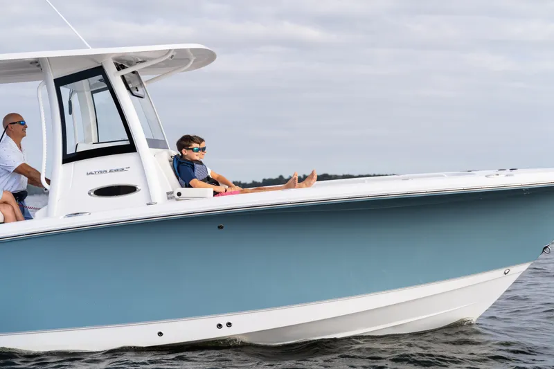 Slide: The Image of 2026 Sea Hunt Ultra 285 Coffin Box boat cruising with passengers on a calm day. - 31