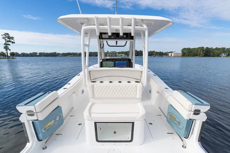 Slide: The Image of 2026 Sea Hunt Ultra 285 Coffin Box boat interior with seating, on calm water. - 4