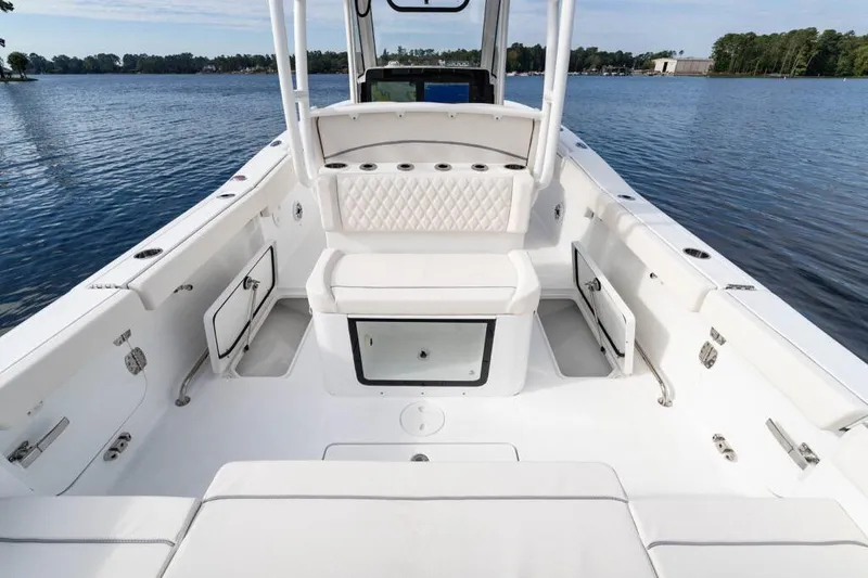 Slide: The Image of 2026 Sea Hunt Ultra 285 Coffin Box boat interior on a serene lake. - 5