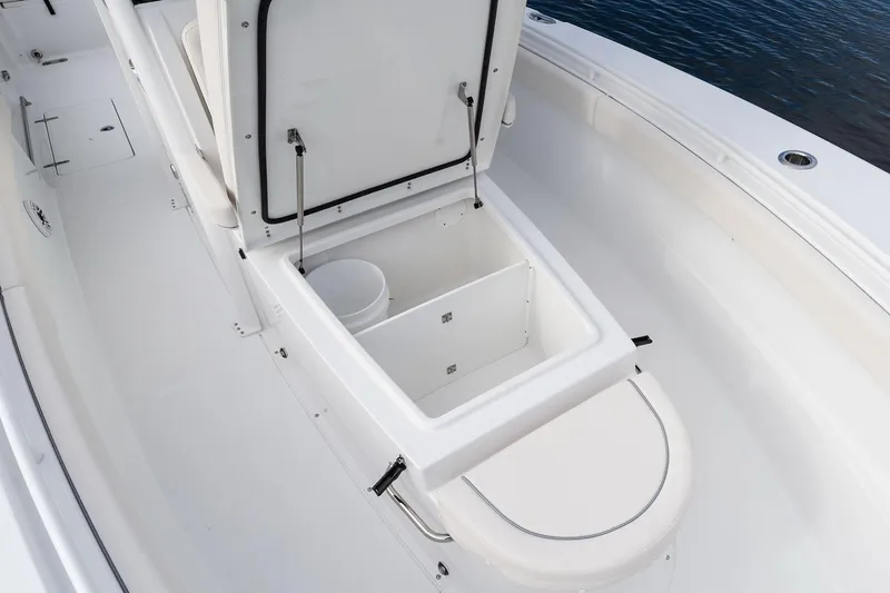 Slide: The Image of 2026 Sea Hunt Ultra 285 Coffin Box interior with seating and storage compartment. - 8