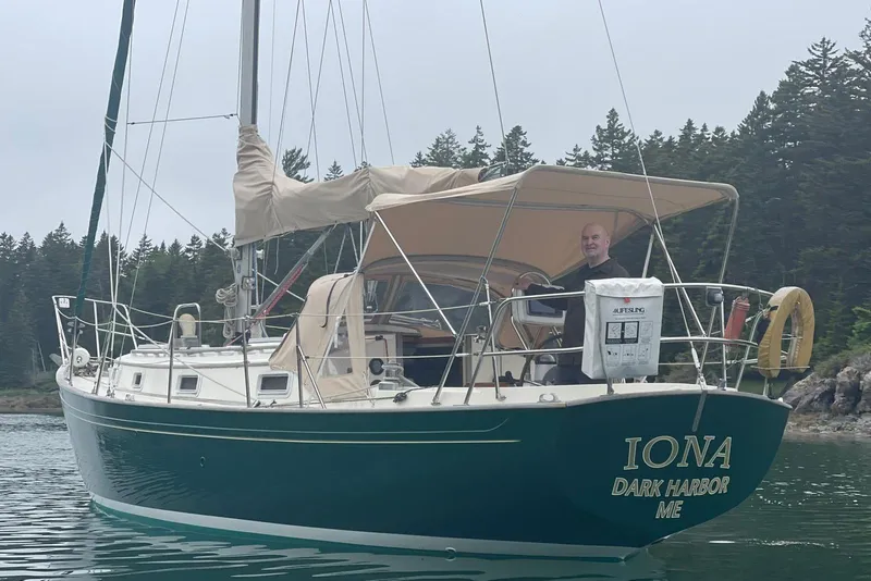 Slide: The Image of 1986 Victoria 34 Sloop "IONA" sailing near forested shoreline, Dark Harbor, ME. - 0