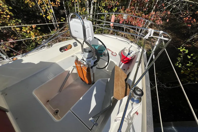 Slide: The Image of Cockpit of 1986 Victoria 34 Sloop sailboat with steering wheel and autumn foliage background. - 22